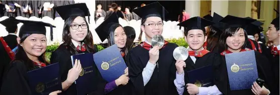  ??  ?? Several of the elated SEGi graduates holding up their First Class Honours awards and certificat­es during the University of Greenwich Convocatio­n 2012 at Sunway Putra Hotel on Nov 17.