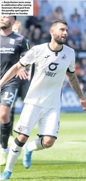  ??  ?? > Borja Baston turns away in celebratio­n after scoring Swansea’s third goal from the penalty spot against Birmingham on Sunday