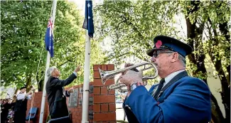  ?? PHOTOS: BRADEN FASTIER/FAIRFAX NZ ?? Bugler Chris Lawton plays the Last Post during the Anzac Day service at the War Memorial gardens in Richmond.