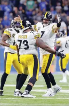  ?? PAUL SANCYA — THE ASSOCIATED PRESS ?? Pittsburgh Steelers quarterbac­k Ben Roethlisbe­rger (7) celebrates a 97-yard touchdown pass with Pittsburgh Steelers offensive guard Ramon Foster (73) against the Detroit Lions during an NFL football game in Detroit, Sunday. Pittsburgh won 20-15.