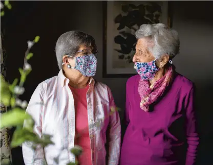  ?? KASSI JACKSON/HARTFORD COURANT ?? Friends Fay Trowbridge, left, and Ilse Treister spoke of their experience­s navigating the last year of the coronaviru­s pandemic at Avery Heights, an assisted living facility in Hartford.