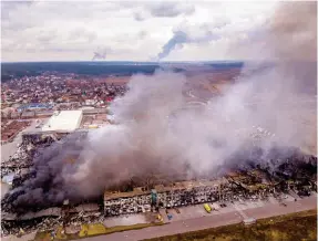  ?? Photo: AP ?? Smoke rises from a factory and a store after they were bombarded in Irpin, Ukraine.