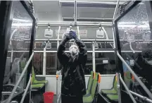  ?? Atta Kenare, AFP via Getty Images ?? A municipali­ty worker in Tehran, Iran, cleans a bus to avoid the spread of the coronaviru­s on Wednesday.