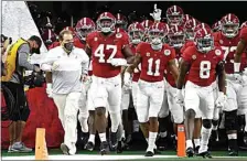  ?? RON JENKINS / AP ?? Alabama head coach Nick Saban, front left, jogs onto the field with his team for their Rose Bowl game against Notre Dame on Jan. 1 in Arlington, Texas.