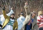  ?? GENE WALSH — DIGITAL FIRST MEDIA ?? Eagles players Fletcher Cox and Chris Long wave to fans during their Victory Parade on February 8.