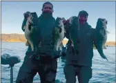  ?? COURTESY PHOTO ?? Lake County fishermen Brad Amodeo (left) and Mark Crutcher hold up four of the five fish they caught Saturday to win the New Jen team bass tournament on Clear Lake. Their biggest fish was 8.47 pounds.