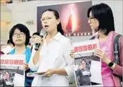  ?? Johnson Lai Associated Press ?? LEE CHING-YU, center, seeks informatio­n about her husband, Taiwanese human rights activist Lee Ming-che, who has been arrested by China.