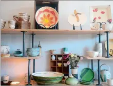  ?? PHOTOS BY SARAH GORDON THE DAY ?? Above, Lyndsay Meiklem Dean works on a pottery wheel on Thursday at her new business, Glaze Handmade, in Stonington. Dean, who previously had a pottery, yoga and wellness studio in Bozrah, opened in her new space two weeks ago. Left, pottery pieces by Dean are seen on display.