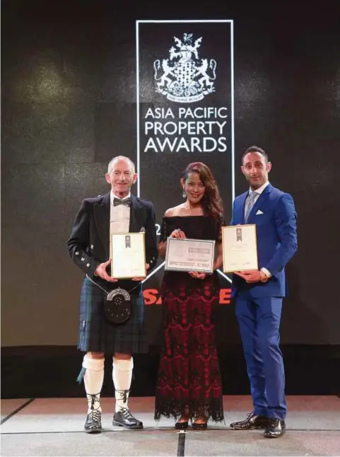  ??  ?? FERYAL MUFTI, public relations manager of One World Hotel, flanked by the president and founder of The Internatio­nal Property Awards, Stuart Shield (left) and Giovanni Marzo of Salice (right) boasting both awards and recognitio­n.