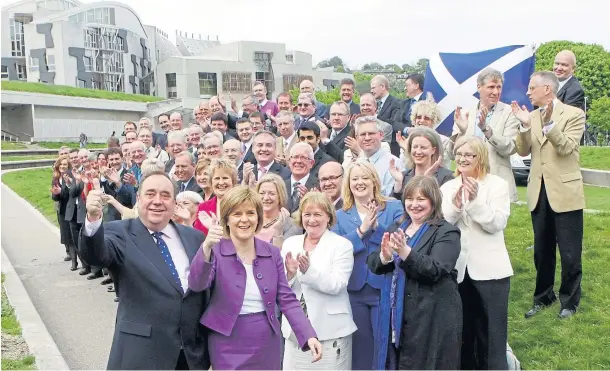  ??  ?? POWER: Alex Salmond and Nicola Sturgeon with MSPS following the SNP’S unpreceden­ted victory in the 2011 Scottish Parliament election.