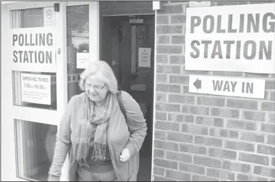  ??  ?? A resident leaves the polling station after casting her vote in the Eastleigh by-election in West End, Hampshire, southern England Thursday Feb. 28. Britain’s political parties are contesting a special election after a campaign overshadow­ed by...