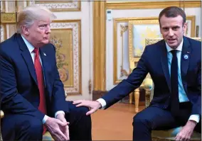  ??  ?? FEELY: Mr Macron moves down to Mr Trump’s knee, but still gets no response