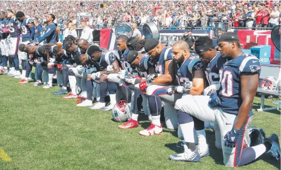  ?? Picture: GETTY ?? New England Patriots players kneel during the national anthem before a game against the Houston Texans in a protest against Donald Trump.