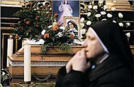  ?? BEATA ZAWRZEL/AP ?? beside the casket and photo of 110-year-old Roman Catholic Sister Cecylia Roszak, believed to be the world’s oldest nun, during her funeral ceremonies Thursday in Krakow, Poland. Roszak, recognized as helping Jews during the Holocaust, died last week.