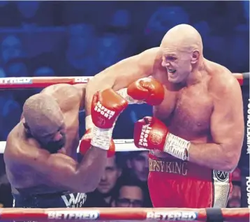  ?? ?? ↑ Tyson Fury, right, in action against Derek Chisora in their WBC World Heavyweigh­t title fight