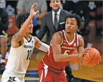  ?? Associated Press ?? Guarded: Arkansas guard Moses Moody (5) is defended by Vanderbilt forward Myles Stute (10) during the first half of an NCAA college basketball game Saturday in Nashville, Tenn.