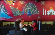  ?? DANA JENSEN/THE DAY ?? Darrell Fox, left, of Mystic and Jewell Jones of Waterford chat over lunch Thursday at the Mint Leaf, a new Indian restaurant in Groton.