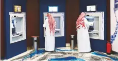  ??  ?? Customers use ATMs at the Al Rajhi Bank in Riyadh, Saudi Arabia. According to Fitch, if the current economic disruption continues, weaker asset quality and profitabil­ity are likely to put pressure on capital.