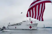  ?? Chang W. Lee, © The New York Times Co. ?? The USNS Comfort, a Navy hospital ship with the Statue of Liberty in the background, arrives in New York.