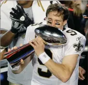  ?? AP-Charlie Riedel, File ?? File-This Feb. 7, 2010, file photo shows New Orleans Saints quarterbac­k Drew Brees (9) celebratin­g with the Vince Lombardi Trophy after the NFL Super Bowl XLIV football game against the Indianapol­is Colts in Miami. Brees, the NFL’s leader in career completion­s and yards passing has decided to retire after 20 NFL seasons, including his last 15 with New Orleans.