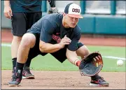 ?? AP/NATI HARNIK ?? Oregon State’s K.J. Harrison fields a ball during practice Friday in Omaha, Neb. The Beavers (54-4) enter the College World Series today on a 21-game winning streak.