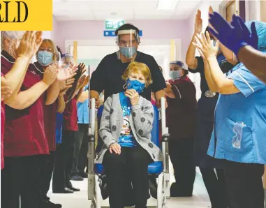  ?? JACOB KING / POOL VIA REUTERS ?? Margaret Keenan, 90, is applauded Tuesday after becoming the first person in the U.K. to receive a COVID-19 vaccine.