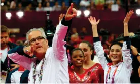  ?? Photograph: Thomas Coex/AFP/Getty Images ?? John Geddert celebrates after the US women’s Olympic gymnastics team he coached won the team gold medal at the 2012 Olympics in London.