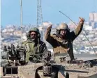  ?? JACK GUEZ/AFP VIA GETTY IMAGES ?? An Israeli army soldier gestures while seated in the turret of a tank along the border between southern Israel and the Gaza Strip on Wednesday.