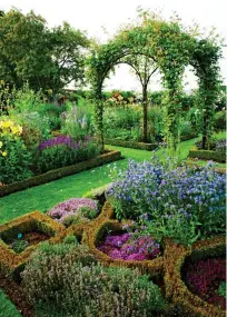  ??  ?? HIGH POINTS: A metal gazebo makes a stunning centrepiec­e among mixed borders, top, and, above, climbers scramble over a wooden archway