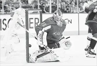  ?? JONATHAN NEWTON THE WASHINGTON POST ?? A puck gets by Capitals goaltender Braden Holtby in the second period of Game 3 on Tuesday night against the Tampa Bay Lightning in Washington.