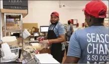  ?? AP ?? Workers prepare meals in the B.Good ghost kitchen at Kitchen United’s Chicago location. Kitchen United builds kitchens for restaurant­s looking to enter new markets through delivery or take-out only.