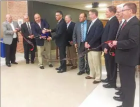  ?? DIGITAL FIRST MEDIA FILE PHOTO ?? Former Pottsgrove School Board President Matt Alexander and Superinten­dent William Shirk cut the ribbon last year dedicating the expanded and renovated Pottsgrove High School.