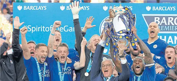  ?? REUTERS ?? Leicester City’s Wes Morgan and manager Claudio Ranieri lift the trophy as they celebrate winning the Premier League.