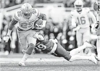  ?? MIKE CARTER, USA TODAY SPORTS ?? Running back Mike Weber, left, and Ohio State eked out a 17-16 win against Michigan State on Saturday and remained No. 2 in the College Football Playoff rankings this week.