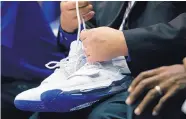  ?? GERRY BROOME/ASSOCIATED PRESS ?? A trainer holds Duke’s Zion Williamson’s shoes after Williamson was hurt when his shoe blew out in Wednesday’s game against North Carolina.