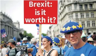  ?? /Reuters ?? Relentless resistance: A woman holds a placard in central London on Saturday as she joins EU supporters calling on the government to give Britons a vote on the final Brexit deal.