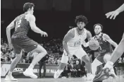  ?? SAM NAVARRO USA TODAY Sports ?? UM’s Norchad Omier, who scored 18 points and grabbed 13 rebounds, drives to the basket against Boston College defenders Jaeden Zackery, right, and Quinten Post.