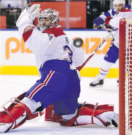  ?? FRANK GUNN/THE CANADIAN PRESS ?? Montreal Canadiens goalie Carey Price put on quite a show Saturday in a 3-2 overtime victory over the Toronto Maple Leafs. The win also launched Price into No. 3 all-time in franchise victories for a goalie with only Jacques Plante and Patrick Roy...