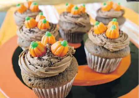  ?? DARREN STONE, TIMES COLONIST ?? Moist and chocolatey devil’s-food cupcakes are topped with an easy-to-make icing that you spread or pipe on. The Halloween-themed candies decorating the cupcakes are sold in the bulk-foods section of many supermarke­ts.