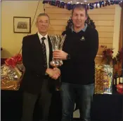  ??  ?? Golfer of the year winner Paul Kavanagh being presented with his prize by Courtown Golf Club Captain Keith Reid.