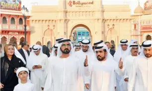  ??  ?? An official briefs Shaikh Mohammed about the progress of work outside the Bollywood Parks Dubai.