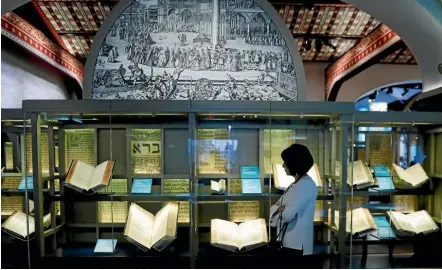  ??  ?? A visitor looks at various Bibles published over the centuries during a preview visit at the Museum of the Bible in Washington, DC this week.