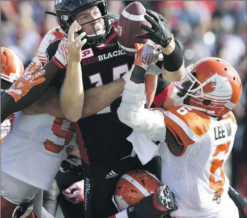  ?? THE CANADIAN PRESS ?? Redblacks quarterbac­k Ryan Lindley tries to control the ball as he attempts a sneak against the Lions. Lindley should get the start against the Bombers on Friday.