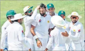  ?? AFP ?? Pakistan spinner Bilal Asif (C) celebrates with teammates after dismissing Australia opener Usman Khawaja on the third day of the first Test in Dubai on Tuesday.