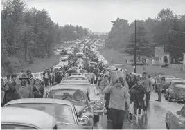  ?? AP file, 1969 ?? Hundreds of rock music fans jam a highway leading from Bethel, N.Y., as they try to leave the Woodstock Music and Art Festival. More than 400,000 people attended the Woodstock festival, which was staged 80 miles northwest of New York City.