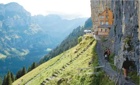  ?? CAMERON HE WITT ?? At Switzerlan­d’s Ebenalp, you can stay in this cliffside guesthouse and enjoy stunning mountain scenery.