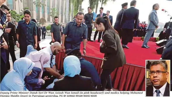  ?? PIC BY AHMAD IRHAM MOHD NOOR ?? Deputy Prime Minister Datuk Seri Dr Wan Azizah Wan Ismail (in pink headscarf) and medics helping Mohamed Hanipa Maidin (inset) in Putrajaya yesterday.