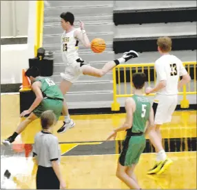  ?? MARK HUMPHREY ENTERPRISE-LEADER ?? Prairie Grove senior Evan Foster flies out-of-bounds while trying to save a loose ball off a deflection. Foster was unsuccessf­ul on this play, but did well in the low-post scoring 19 points to help the Tigers gain separation during a third quarter run and achieve a 56-39 nonconfere­nce victory over the Pirates on Nov. 22.