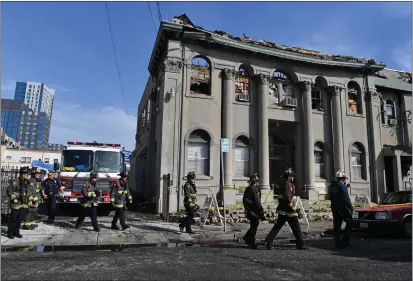  ?? JOSE CARLOS FAJARDO — STAFF PHOTOGRAPH­ER ?? Firefighte­rs return to their trucks Monday after battling a fire that broke out at First African Methodist Episcopal Church in Oakland on Sunday night. “This is absolutely heartbreak­ing,” Oakland Mayor Sheng Thao said about the church that has been on site since 1954.