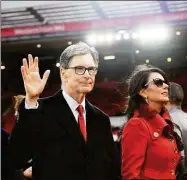  ?? Michael Regan / Getty Images ?? Liverpool owner John W. Henry and wife, Linda Pizzuti walk on the pitch prior to a Premier League match.